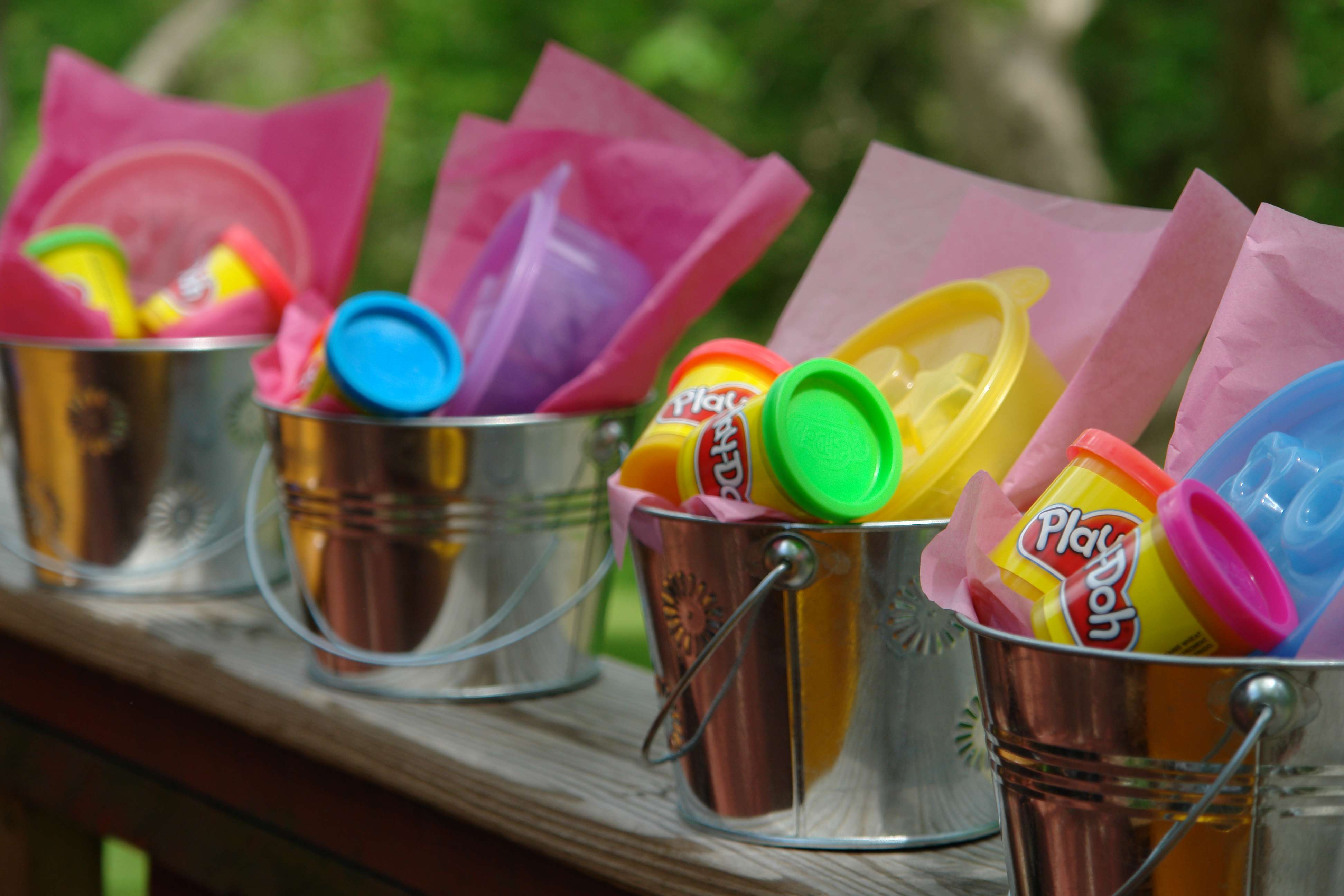 Play-dohs arranged uniquely in small bucket package as a child's birthday souvenir